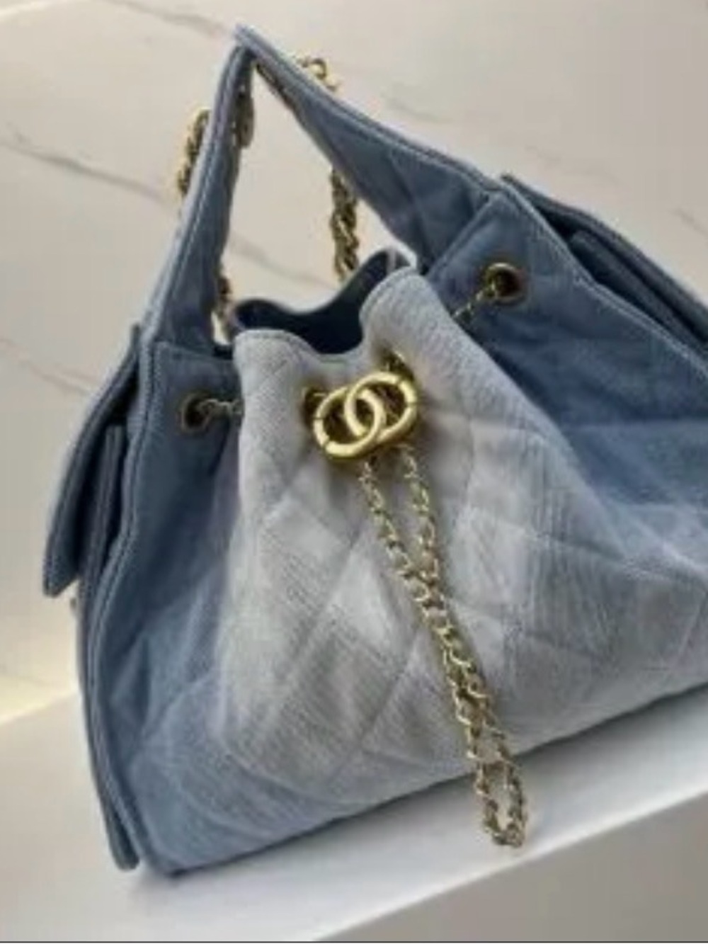Quilted Light Blue Drawstring Shoulder Bag with Gold Chain
